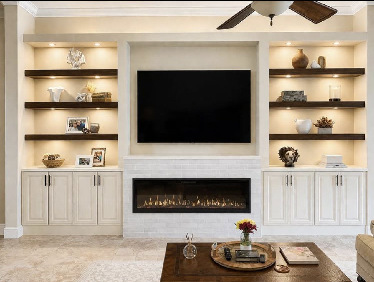 Custom built-in shelving and cabinetry flanking a linear fireplace