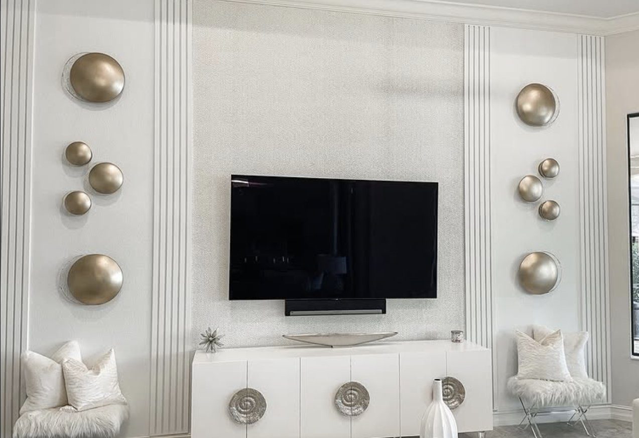 Fluted accent wall with custom millwork and a wall-mounted television
